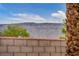 Backyard landscaping and views of mountains and desert hills beyond backyard walls at 12283 Lost Treasure Ave, Las Vegas, NV 89138