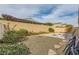 The backyard includes desert landscaping, a brick patio, and a privacy wall, ideal for outdoor enjoyment at 130 Mountain Cedar Ct, North Las Vegas, NV 89031