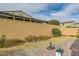 The private backyard has desert landscaping, a brick patio, and a tall block wall for added privacy at 130 Mountain Cedar Ct, North Las Vegas, NV 89031
