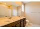 Bathroom showcasing double sinks, a large mirror, and a shower-tub combination at 130 Mountain Cedar Ct, North Las Vegas, NV 89031