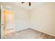 Comfortable bedroom with neutral carpeting, a ceiling fan, and access to another room at 130 Mountain Cedar Ct, North Las Vegas, NV 89031
