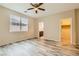 Inviting bedroom with plank flooring, ceiling fan, adjacent bath, and walk-in closet at 130 Mountain Cedar Ct, North Las Vegas, NV 89031