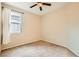 Bedroom with neutral walls, ceiling fan, carpet floors, and window with privacy blinds at 130 Mountain Cedar Ct, North Las Vegas, NV 89031