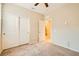 Neutral bedroom featuring plush carpeting, ceiling fan, and closet with sliding doors at 130 Mountain Cedar Ct, North Las Vegas, NV 89031