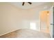 Neutral bedroom with carpeted floors, ceiling fan, and open door to en suite bathroom at 130 Mountain Cedar Ct, North Las Vegas, NV 89031