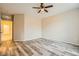Comfortable bedroom with wood-look flooring, a ceiling fan, and access to an adjacent room at 130 Mountain Cedar Ct, North Las Vegas, NV 89031