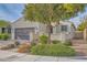 Charming single-story home featuring stucco walls, a tile roof, and a well-maintained front yard with mature landscaping at 130 Mountain Cedar Ct, North Las Vegas, NV 89031
