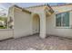 Close-up of the front entrance with a brick pathway leading to an arched entryway of the home at 130 Mountain Cedar Ct, North Las Vegas, NV 89031