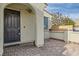 Home entryway with brick paving leading to a modern black door with a small window and an arched entryway at 130 Mountain Cedar Ct, North Las Vegas, NV 89031