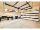 Two-car garage with storage and garage door partially open at 130 Mountain Cedar Ct, North Las Vegas, NV 89031