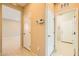 Hallway with multiple doorways, neutral paint, and tiled floor at 130 Mountain Cedar Ct, North Las Vegas, NV 89031