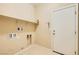 Bright laundry room featuring a door to the exterior, and built in shelving at 130 Mountain Cedar Ct, North Las Vegas, NV 89031