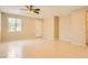 Bright living area features tile flooring, neutral walls, and a ceiling fan for comfortable, modern living at 130 Mountain Cedar Ct, North Las Vegas, NV 89031