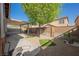Backyard featuring a covered patio area, desert landscaping, and a tree at 132 Soaring Sky Ave, Henderson, NV 89011