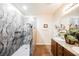 Modern bathroom features a dual sink vanity, granite countertop, and a stylish walk-in shower at 132 Soaring Sky Ave, Henderson, NV 89011