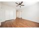 Bedroom with wood floors, ceiling fan, and a large closet with white doors at 132 Soaring Sky Ave, Henderson, NV 89011