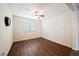 Bright bedroom featuring wood floors, a ceiling fan, and a window with blinds at 132 Soaring Sky Ave, Henderson, NV 89011