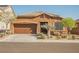 Charming single-story home features a low-maintenance desert landscape, covered entrance, and a two-car garage at 132 Soaring Sky Ave, Henderson, NV 89011