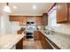 Well-equipped kitchen featuring granite countertops, stainless steel appliances, and ample cabinet space at 132 Soaring Sky Ave, Henderson, NV 89011