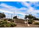 Weston Hills Park sign nestled among greenery and trees on a sunny day at 132 Soaring Sky Ave, Henderson, NV 89011