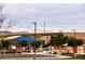 Community playground with colorful equipment, shade, and walking paths for Gathering enjoyment at 132 Soaring Sky Ave, Henderson, NV 89011