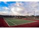 Well-maintained tennis court with nets, fencing, and lights for evening games at 132 Soaring Sky Ave, Henderson, NV 89011