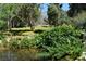 Scenic view of a backyard pond with trees and landscaped greenery in background at 1382 N Trout Canyon Rd, Las Vegas, NV 89124