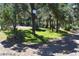 Landscaped backyard featuring mature trees, offering a tranquil retreat with natural beauty at 1382 N Trout Canyon Rd, Las Vegas, NV 89124