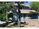 Charming two-story blue home featuring a well-maintained yard and front door at 1382 N Trout Canyon Rd, Las Vegas, NV 89124