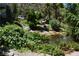 Backyard pond surrounded by lush greenery, a bench, and a peaceful, natural setting at 1382 N Trout Canyon Rd, Las Vegas, NV 89124
