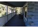 Covered porch with log walls and an outdoor seating area, providing a cozy and inviting space at 1382 N Trout Canyon Rd, Las Vegas, NV 89124