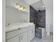 Modern bathroom featuring double vanity, unique lighting, and tiled shower with soaking tub at 1405 Vegas Valley Dr # 312, Las Vegas, NV 89169