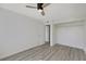 Bright bedroom boasts light wood floors, a ceiling fan, and closet with open shelving at 1405 Vegas Valley Dr # 312, Las Vegas, NV 89169