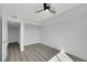 Neutral bedroom features light wood floors, a ceiling fan, and closet with open shelving at 1405 Vegas Valley Dr # 312, Las Vegas, NV 89169