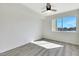 Minimalist bedroom with light wood floors, a ceiling fan, and a bright window view at 1405 Vegas Valley Dr # 312, Las Vegas, NV 89169