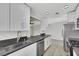 Bright kitchen featuring white cabinets, stainless steel appliances, and dark countertops at 1405 Vegas Valley Dr # 312, Las Vegas, NV 89169
