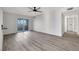 Large living room with wood-look floors features updated lighting, and a sliding glass door at 1405 Vegas Valley Dr # 312, Las Vegas, NV 89169