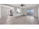 Open concept living room features wood-look floors, updated lighting, and opens to the modern kitchen at 1405 Vegas Valley Dr # 312, Las Vegas, NV 89169