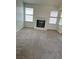 Cozy living room with carpet, fireplace, and natural light from the windows at 149 Cologne Ct, Henderson, NV 89074