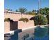 Relaxing swimming pool surrounded by lush greenery and a decorative block wall at 149 Cologne Ct, Henderson, NV 89074