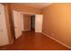 Neutral bedroom featuring wood-look floors, paint and large closet with view into another room at 1900 N Torrey Pines Dr # 225, Las Vegas, NV 89108