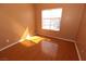 Sunny bedroom with wood-look floors, neutral paint, and a window providing ample natural light at 1900 N Torrey Pines Dr # 225, Las Vegas, NV 89108
