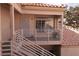 View of front door with landing & railing plus the tile roof above and partial exterior wall at 1900 N Torrey Pines Dr # 225, Las Vegas, NV 89108