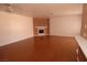 Spacious open-plan living area featuring hardwood floors and a fireplace, with abundant natural light at 1900 N Torrey Pines Dr # 225, Las Vegas, NV 89108