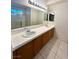 Bathroom featuring double sinks, a large mirror, and tub with shower at 1906 Double Delight Ave, North Las Vegas, NV 89032