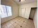 Bedroom with tiled floors and a closet featuring sliding doors, offering functionality and style at 1906 Double Delight Ave, North Las Vegas, NV 89032