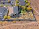 Aerial view of a private residence with a backyard putting green, mature trees, and a desert landscape at 2064 Poetry Ave, Henderson, NV 89052