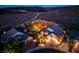 An aerial view of a luxury home boasting a private yard, landscaping, lighting, and mountain views at 2064 Poetry Ave, Henderson, NV 89052