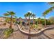 Expansive backyard features a putting green, mature palm trees, manicured landscaping, and privacy at 2064 Poetry Ave, Henderson, NV 89052