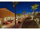 Expansive backyard view featuring palm trees, a dining area, and lush landscaping at 2064 Poetry Ave, Henderson, NV 89052